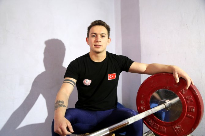 Dünya şampiyonu halterci, kapıcı dairesinde hazırlıklarını sürdürüyor